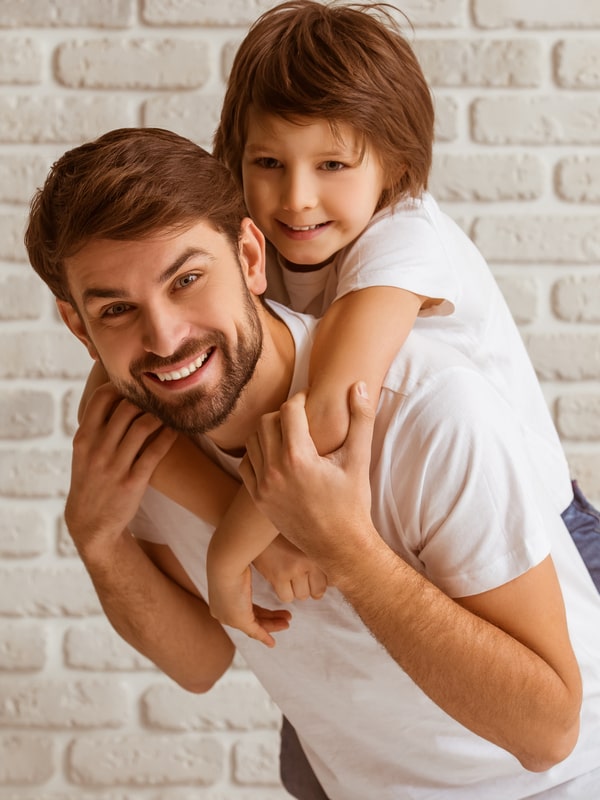 Dad with his young son smiling