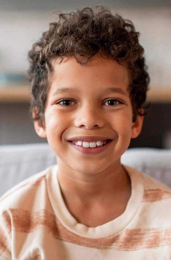 A boy is happily smiling