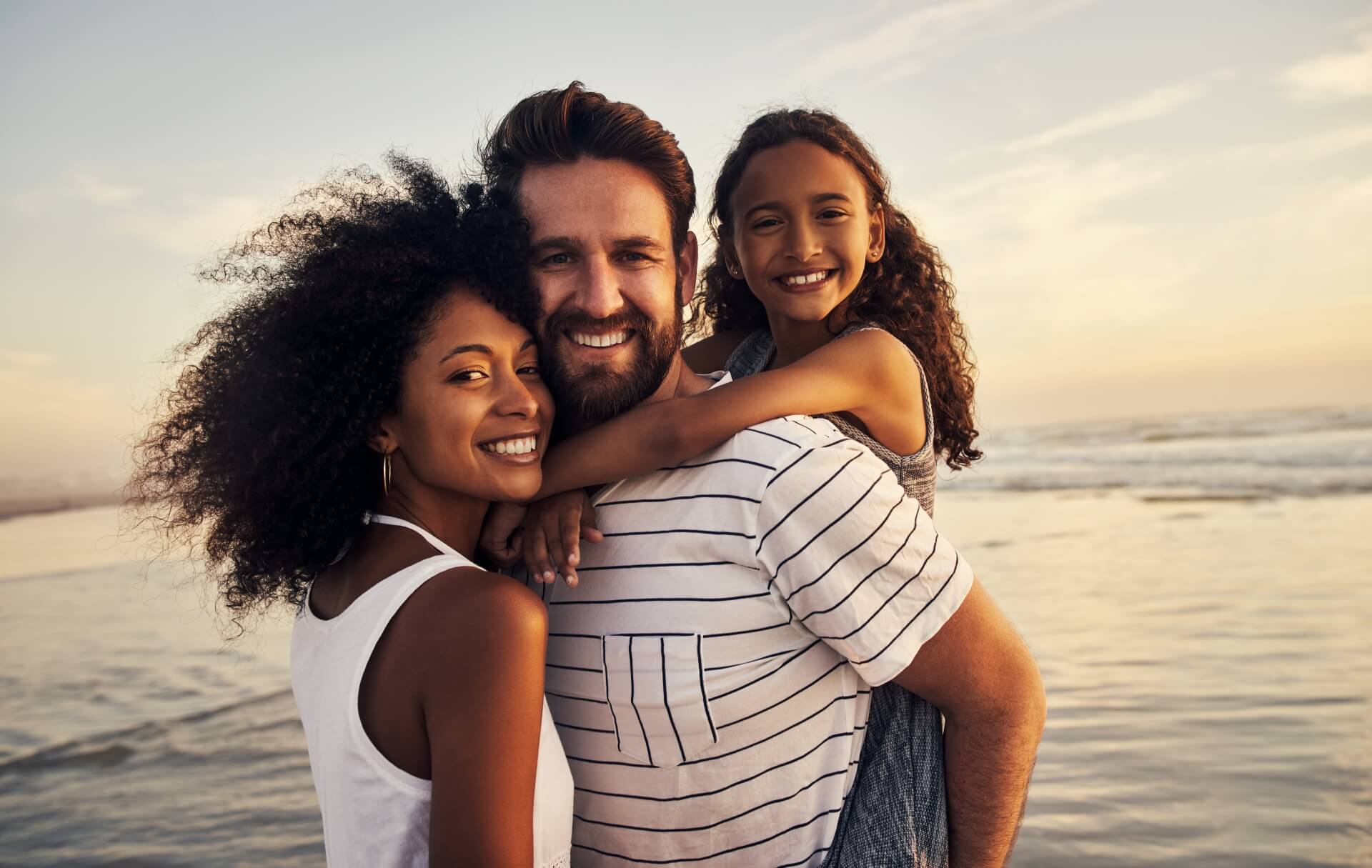 Family is happily hugging and smiling