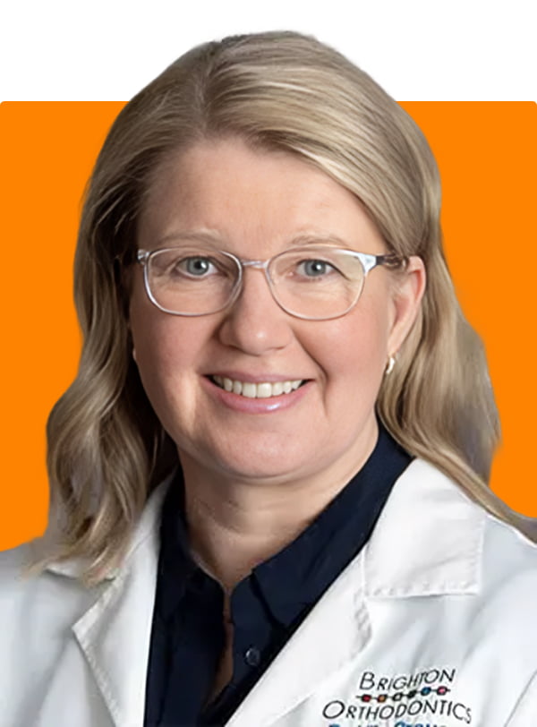 Dr. Ulla Crouse, dentist at Brighton Orthodontics, smiling warmly in her dental uniform