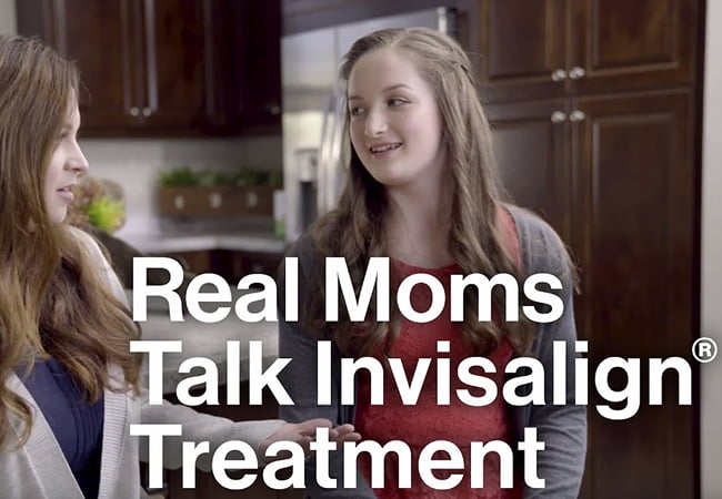 A mother talking about her daughter’s Invisalign treatment at Brighton Orthodontics office