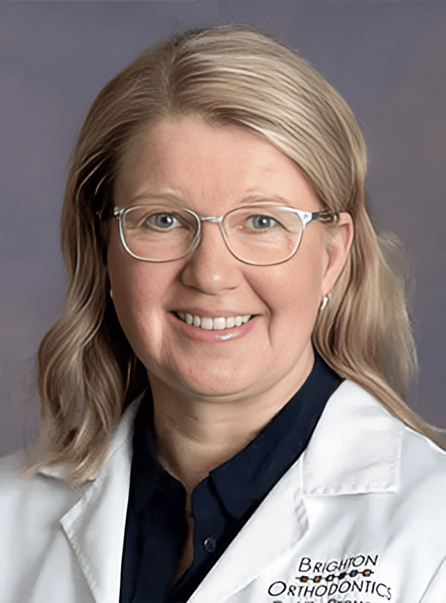 Dr. Ulla Crouse, dentist at Brighton Orthodontics, smiling warmly in her dental uniform